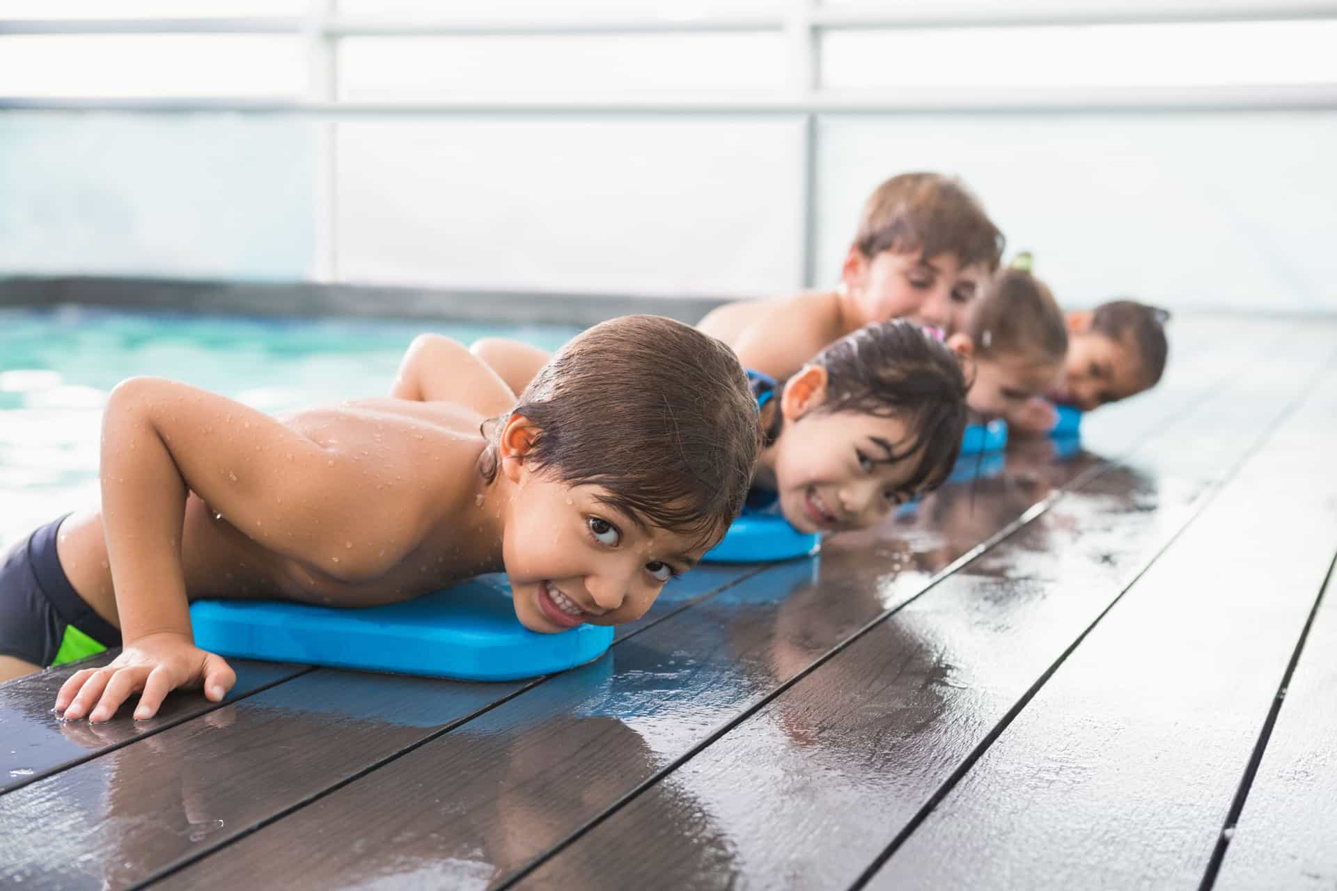 Child resting on side of pool